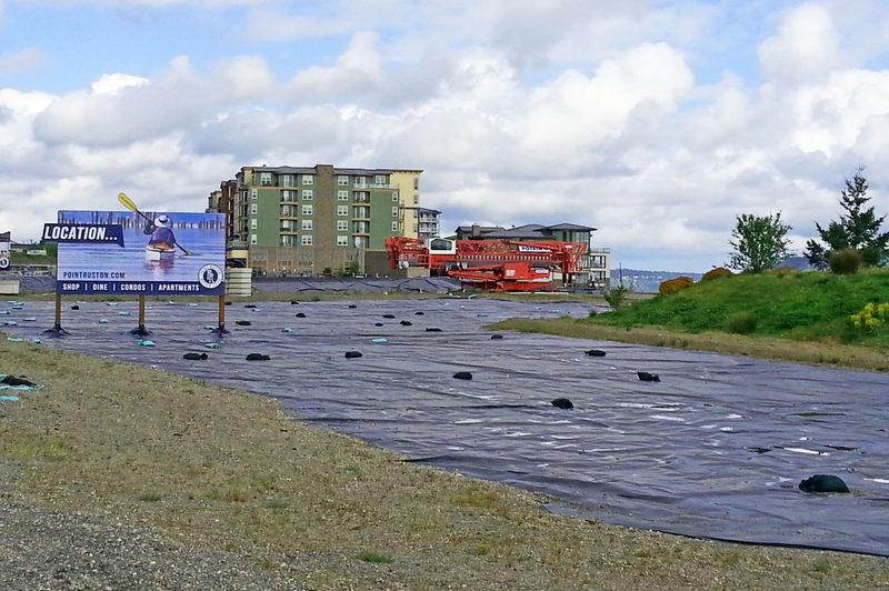 A sign advertises new commercial development at Point Ruston, the former site of a shuttered copper smelter that polluted the surrounding region for around 100 years. The EPA and other government agencies are still working to clean up the contaminated soil in four counties.